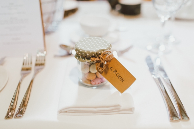 Wedding favour of sugared almonds in a recycled glass jar