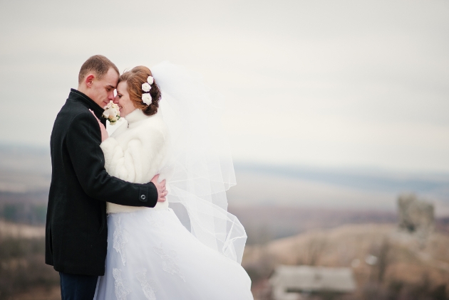 Couple wrapped up warm for winter wedding