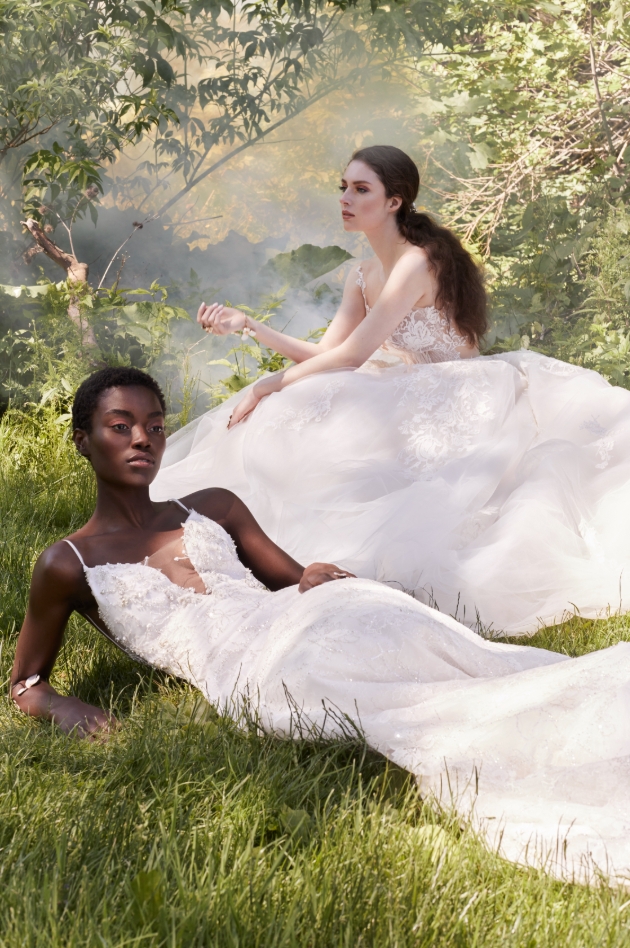 Two models in the woods wearing different style gowns