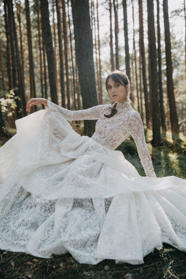 Model in the woods wearing a large billowing wedding dress