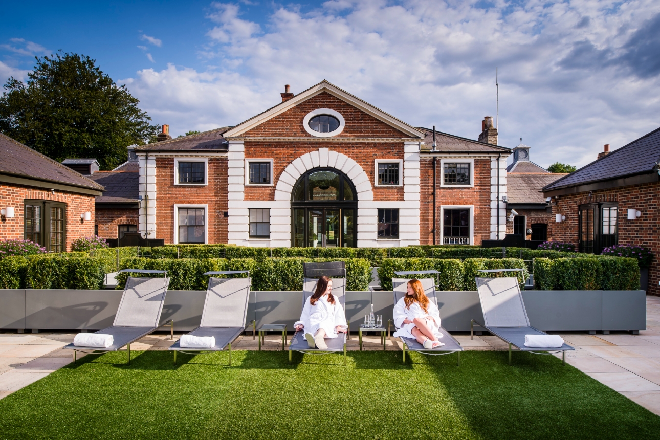 The grove outside shot two brides on a lounger in spa robes