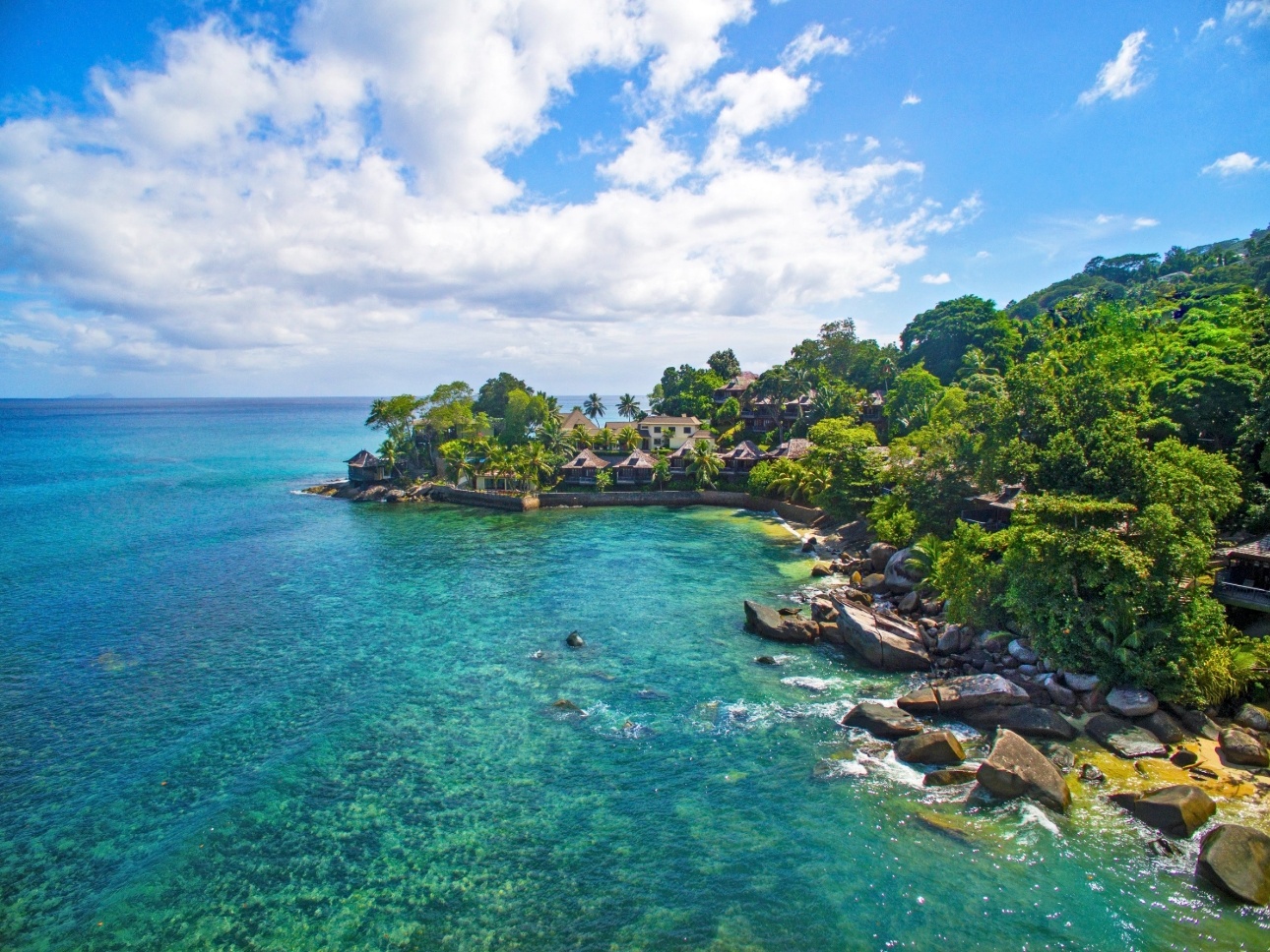 Seychelles Northolme Resort & Spa panoramic view of huts and ocean and island