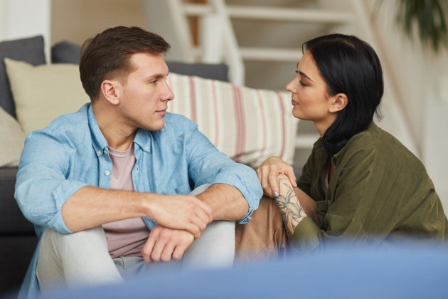 Couple looking sad talking