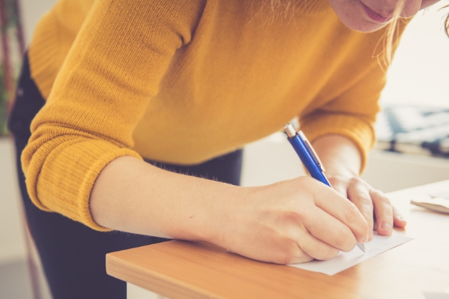 Woman writing an RSVP