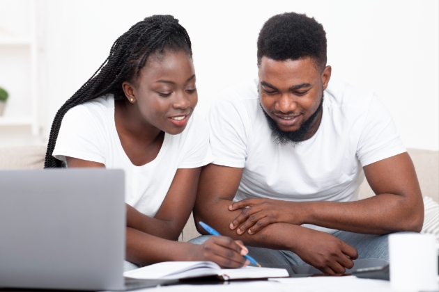 Couple looking at notepad