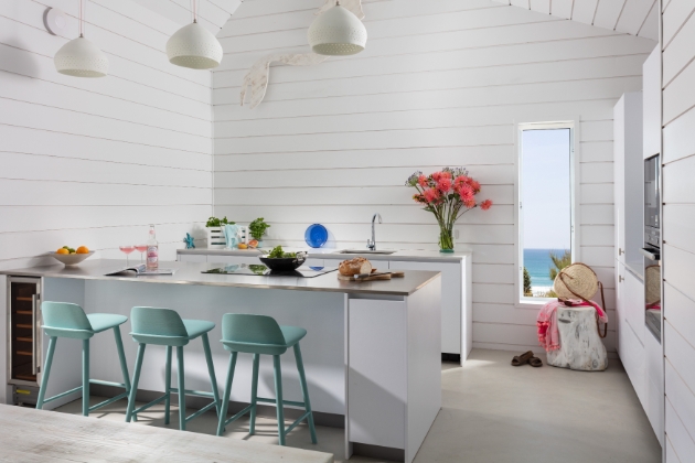 Inside beach house white wood breakfast bar view of sea