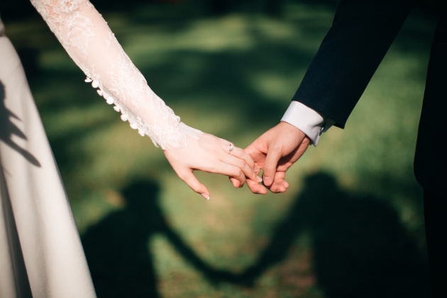 bride and groom close up of holding hands