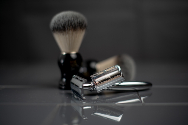 hand holding a gift box and razor products displayed on the table