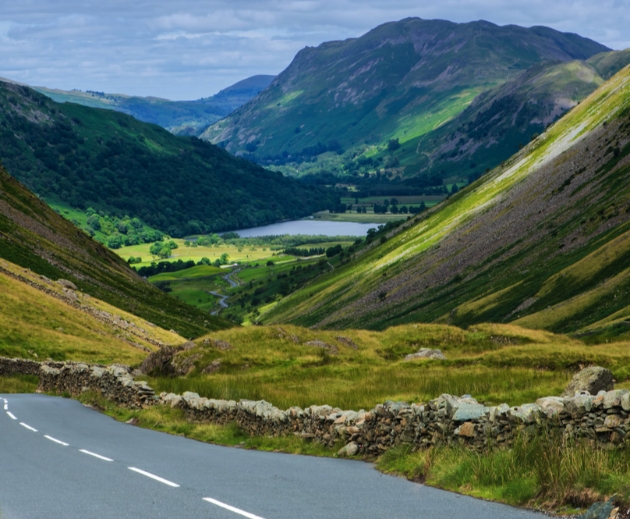 roads winding through hills with lake at end