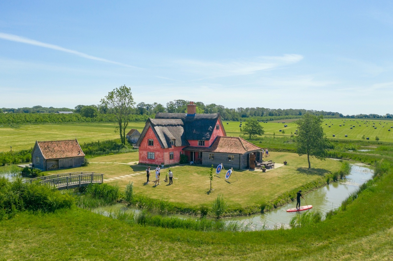 barn on island in fields with moat