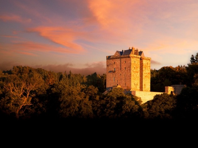 castle at dusk surrounded by woodland