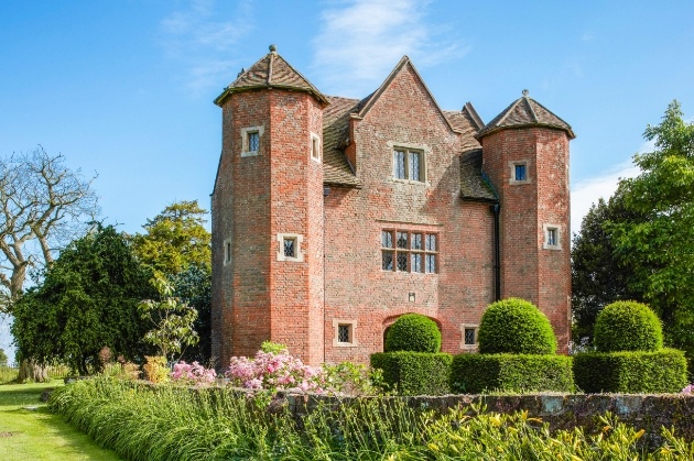 small castle surrounded by gardens