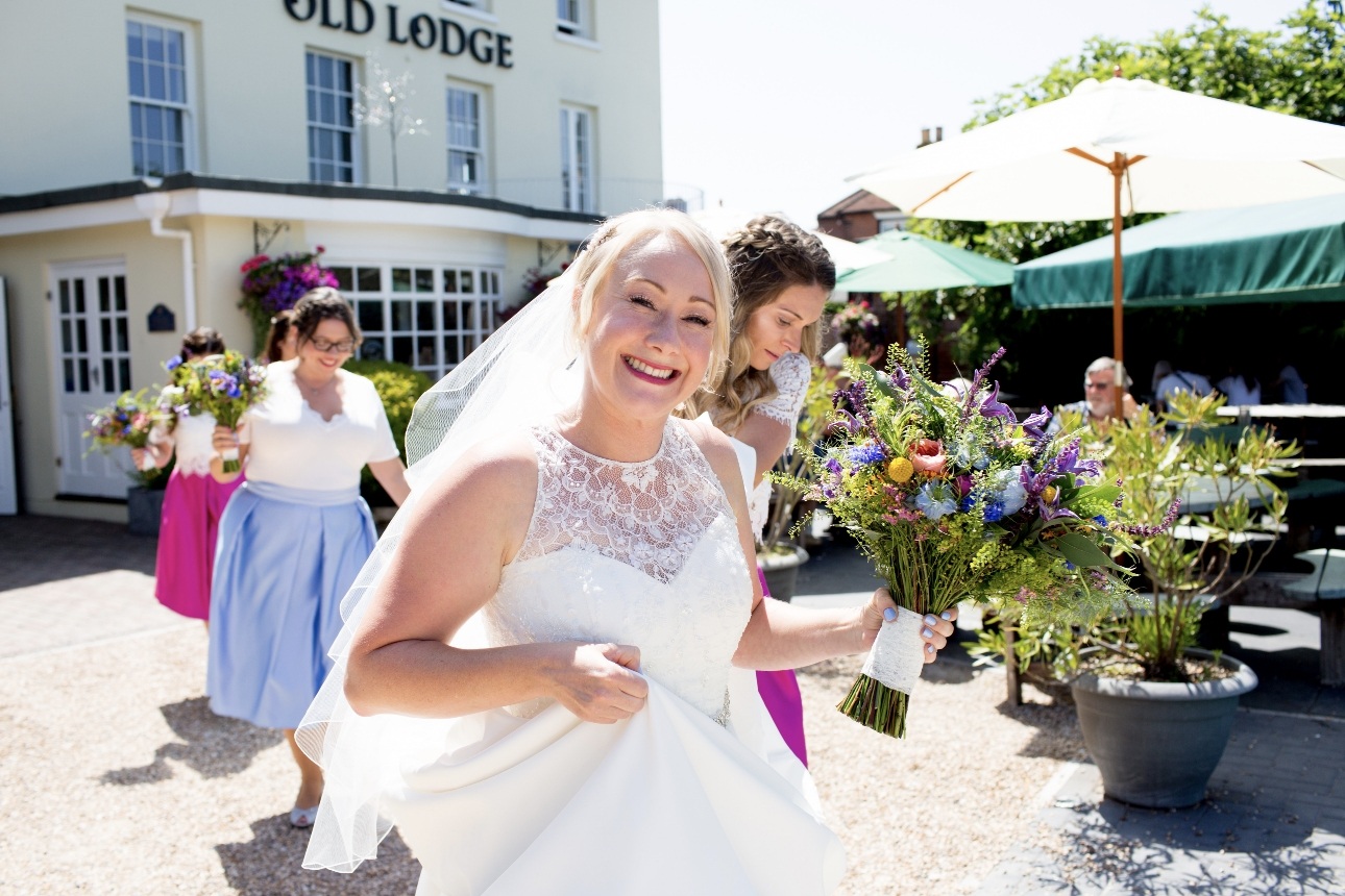 Bride smiles with bridesmaids