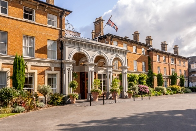 front of hotel, red brick building with white pillars at entrance