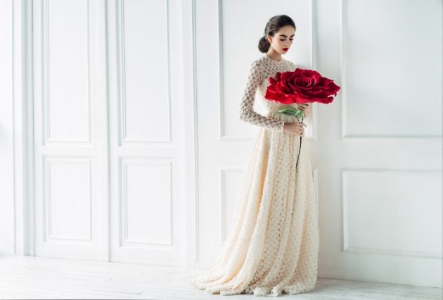 bride holding red rose