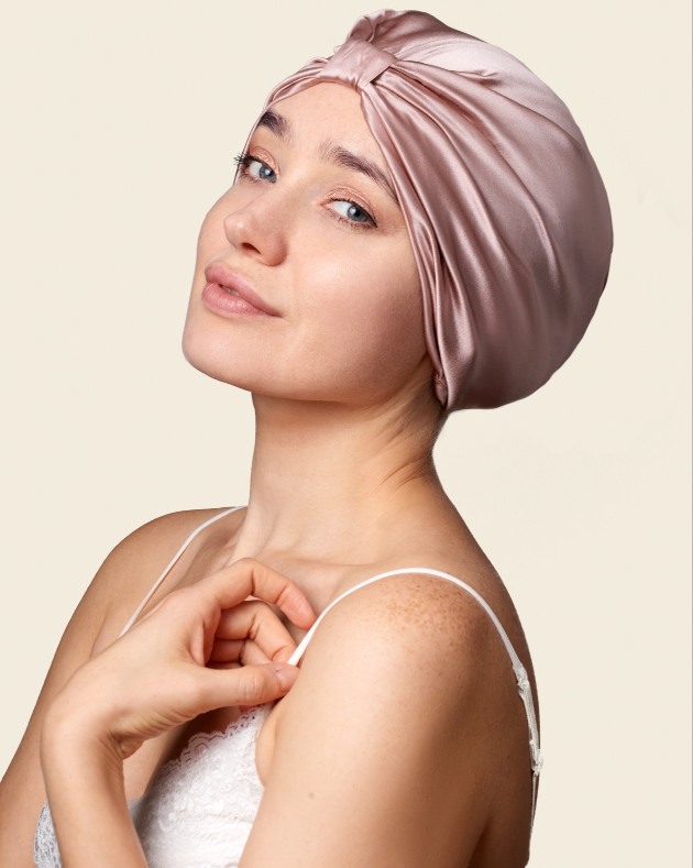 Woman wearing the This is Silk hair wrap in dusky pink