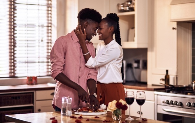 couple cooking together in kitchen