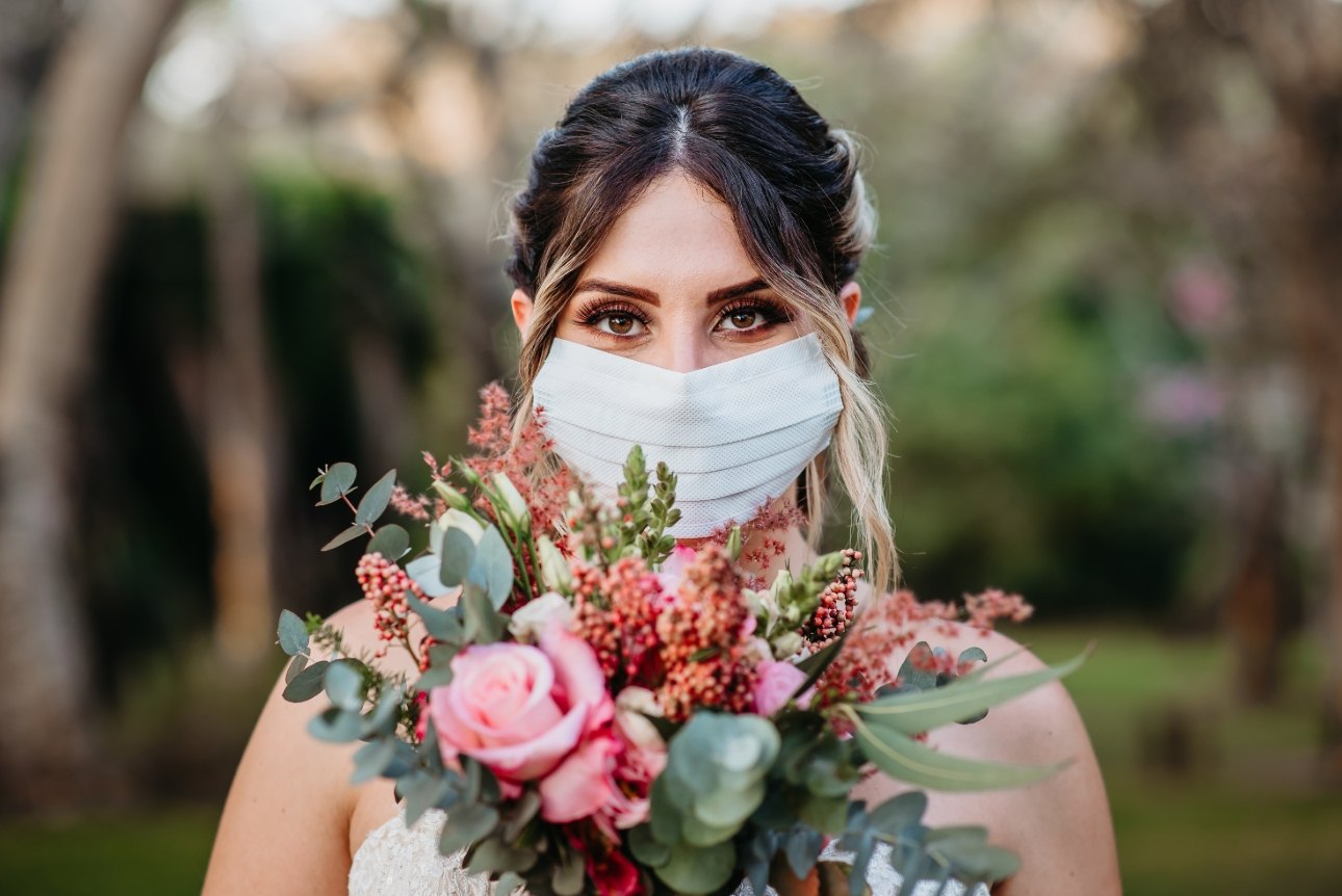 bride in mask with bouquet