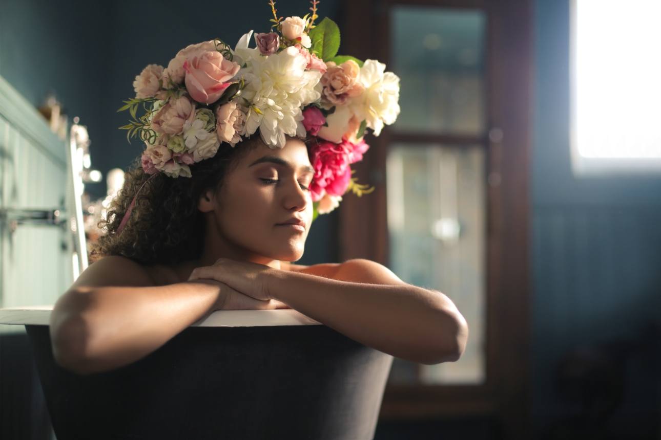 woman in bath floral headwear on