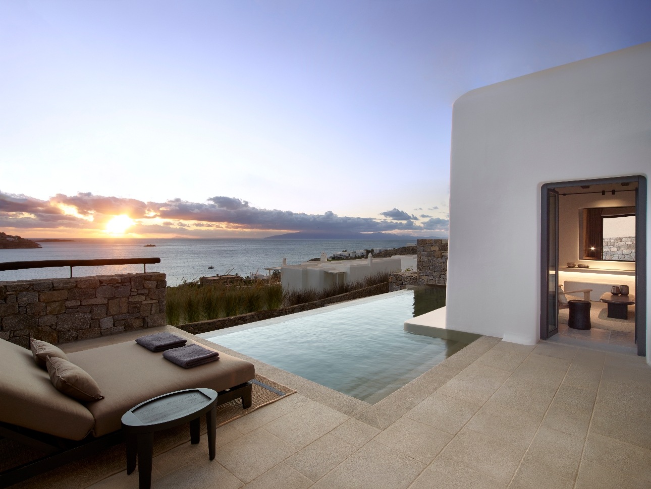 night view of suite with pool and sea in background