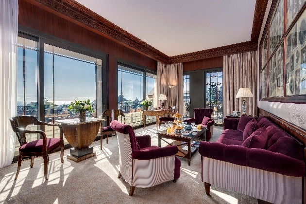 hotel room with city views and burgundy decor
