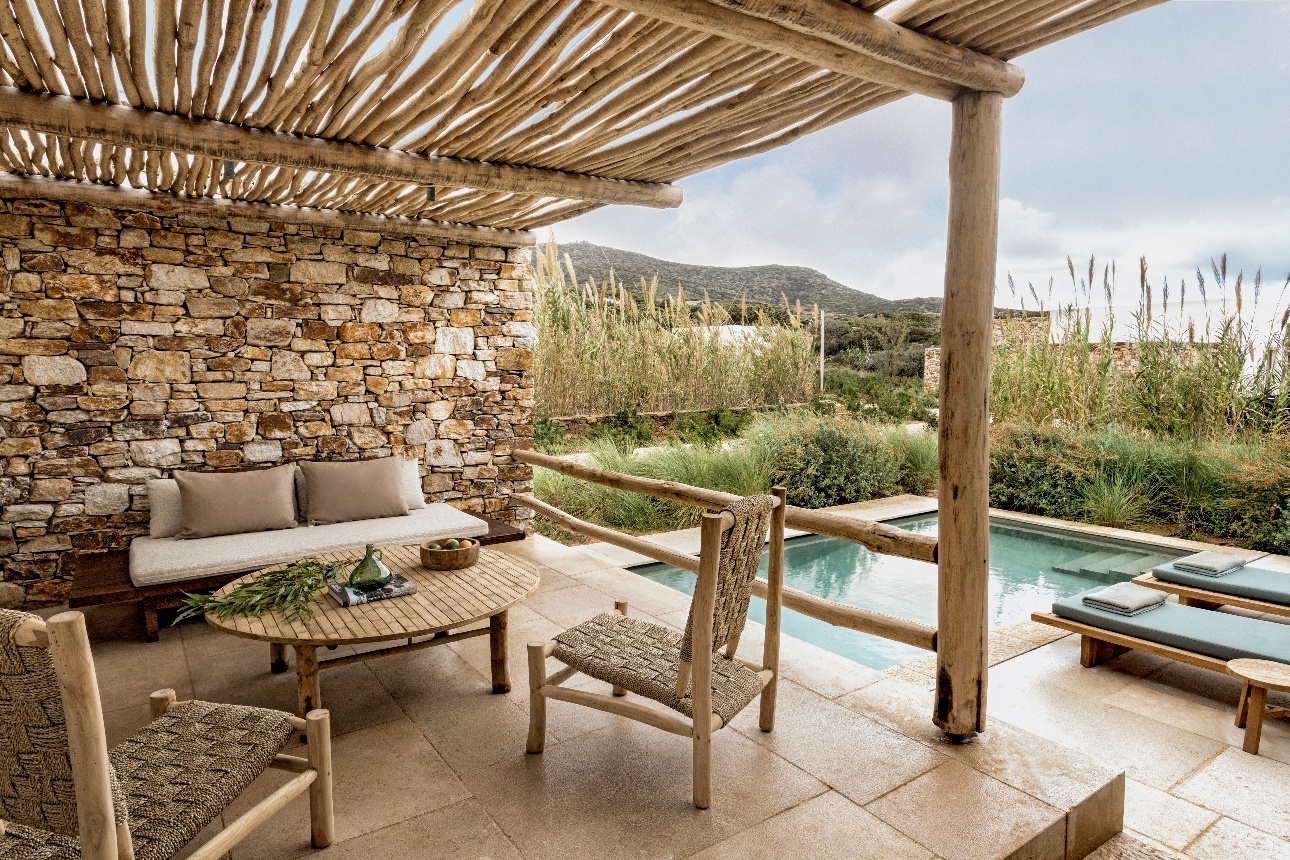 garden view suite with seating outside by little pool surrounded by foliage