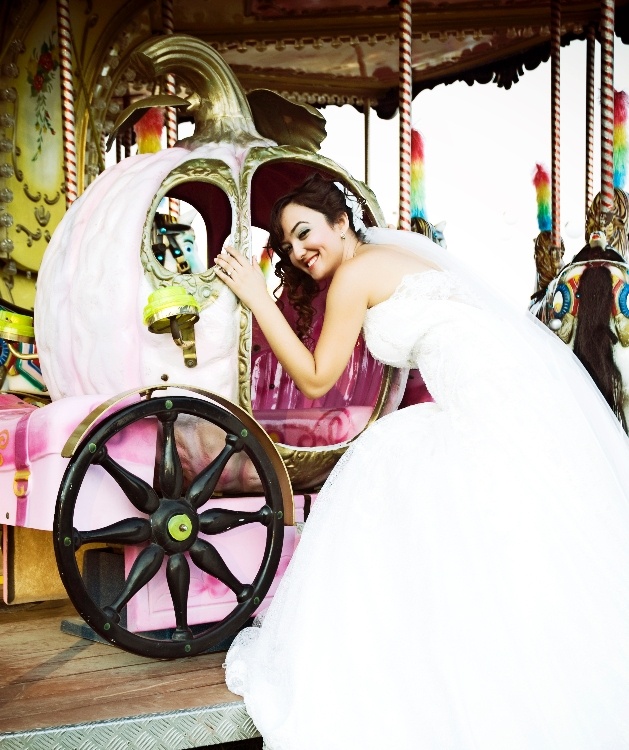 bride climbing in a pumpkin on a carousel