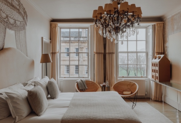 grey and white room with grand chandeliers city views 