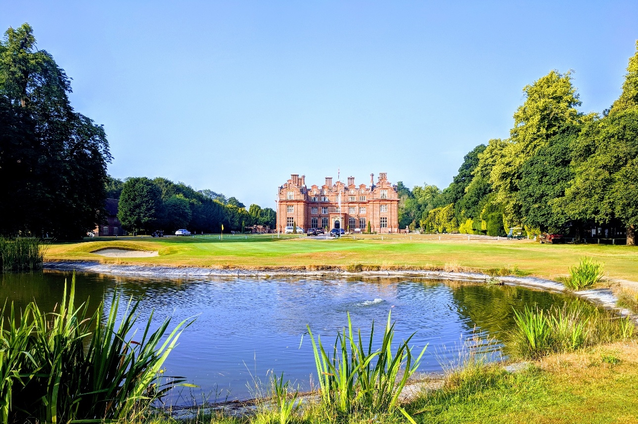 historic mansion with pond in grounds