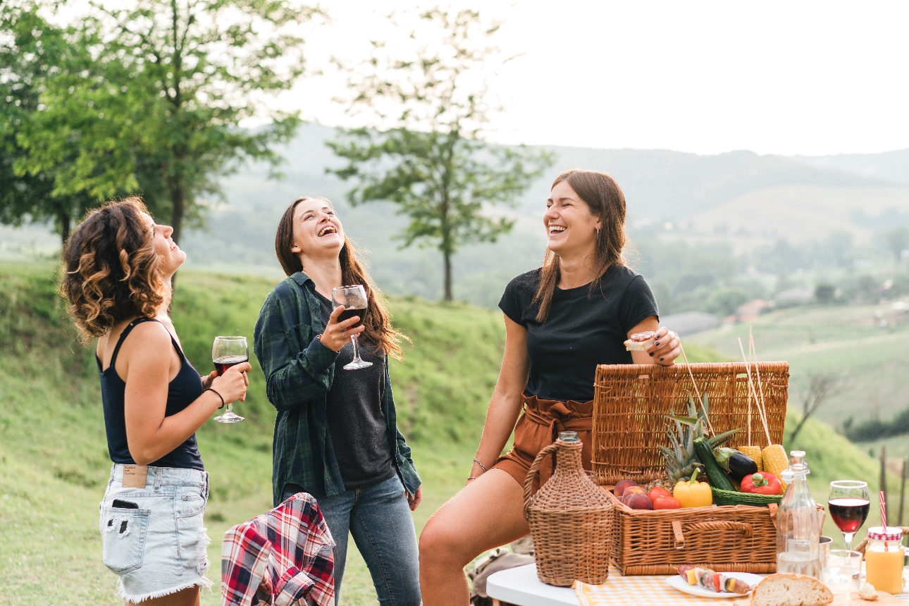 three friends outside with picnic