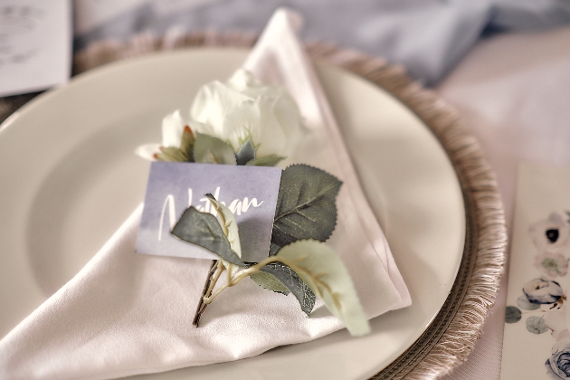wedding place setting with white rose and blue place name