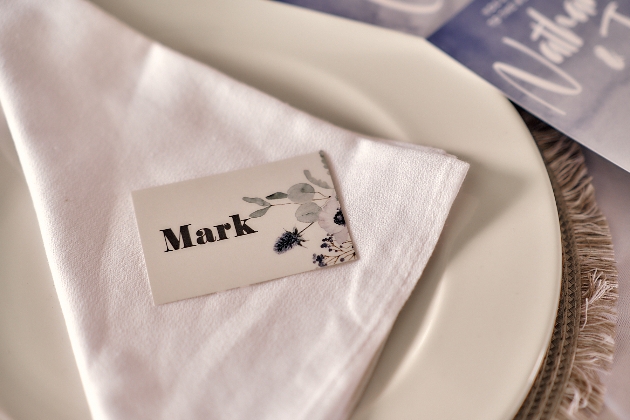 wedding place setting with white napkin and black and white place setting