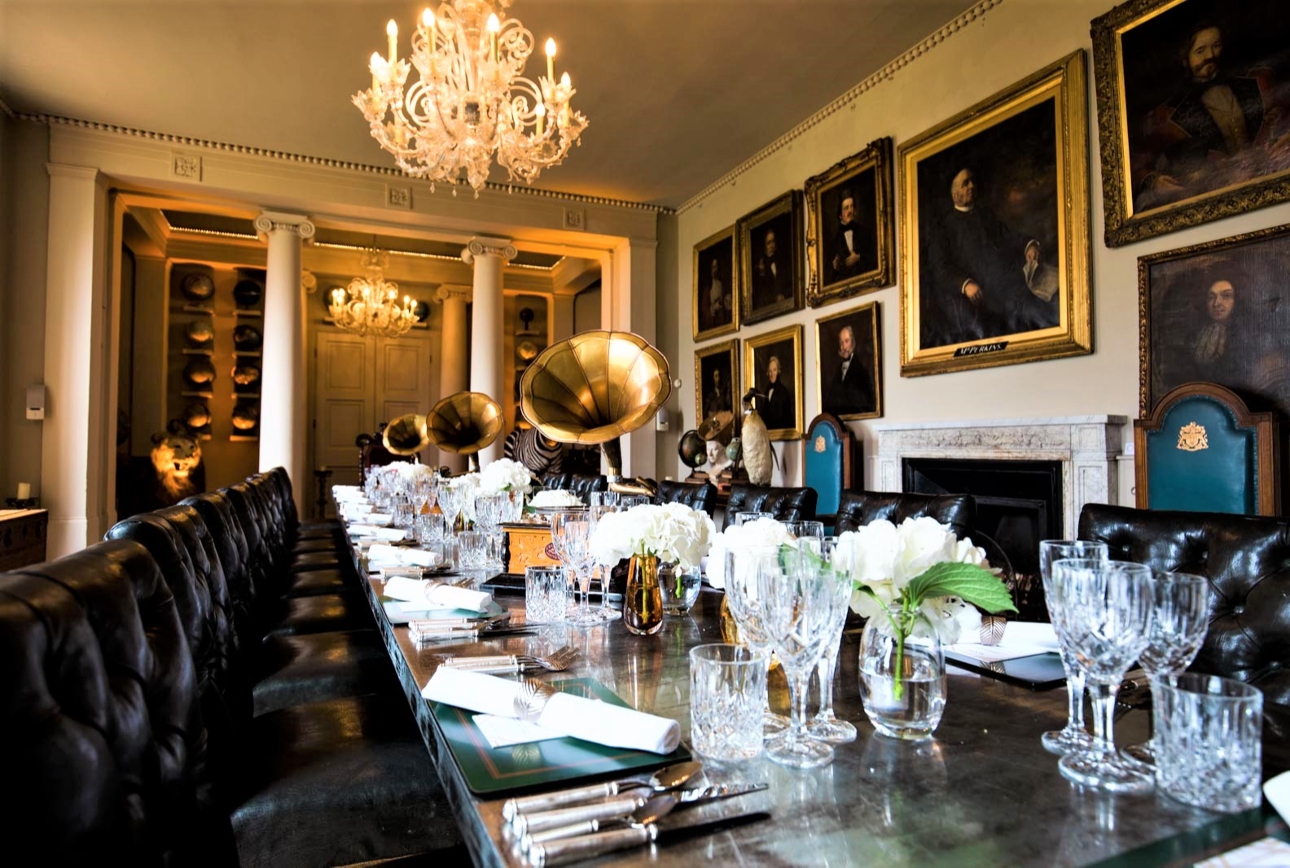 ornate room with art on the walls in gold frames gramophone on tables