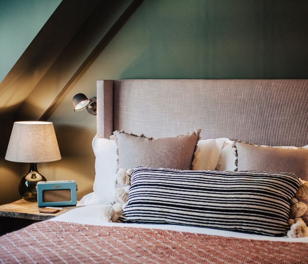 headboard with comfy pillows and lamp