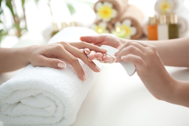 a pair of hands having a manicure