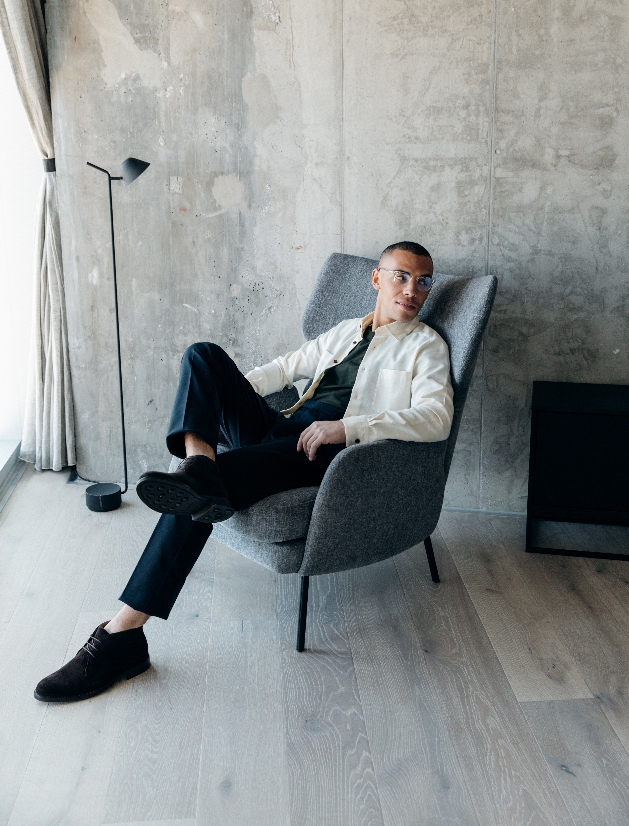 man sitting in chair in new clothes