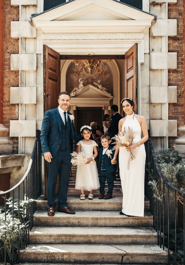 Family stand on steps of ceremony venue