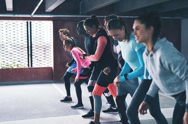 group of people in gym gear preparing for a race