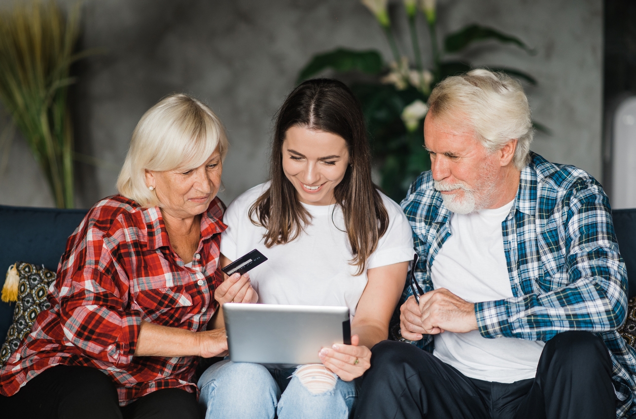 woman at a lap top with her mum and dad either side 