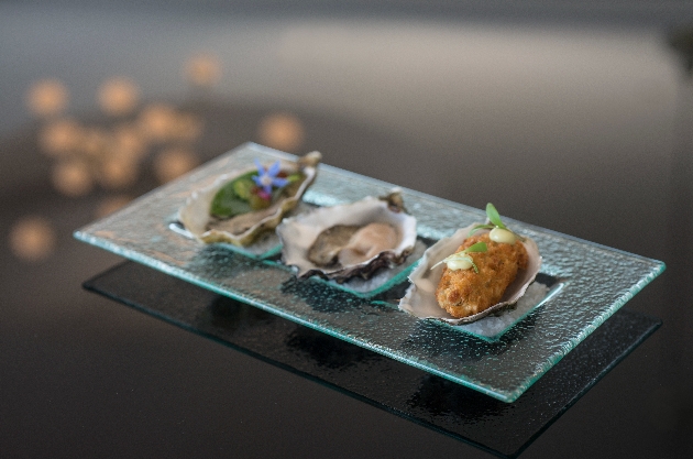 square glass plate of three starters in oyster shelles