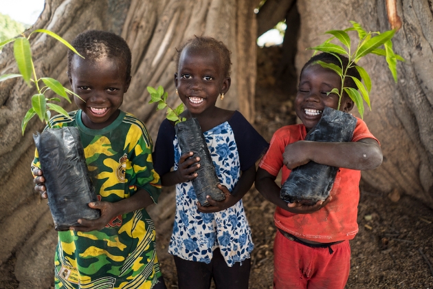 three kids w seedlings