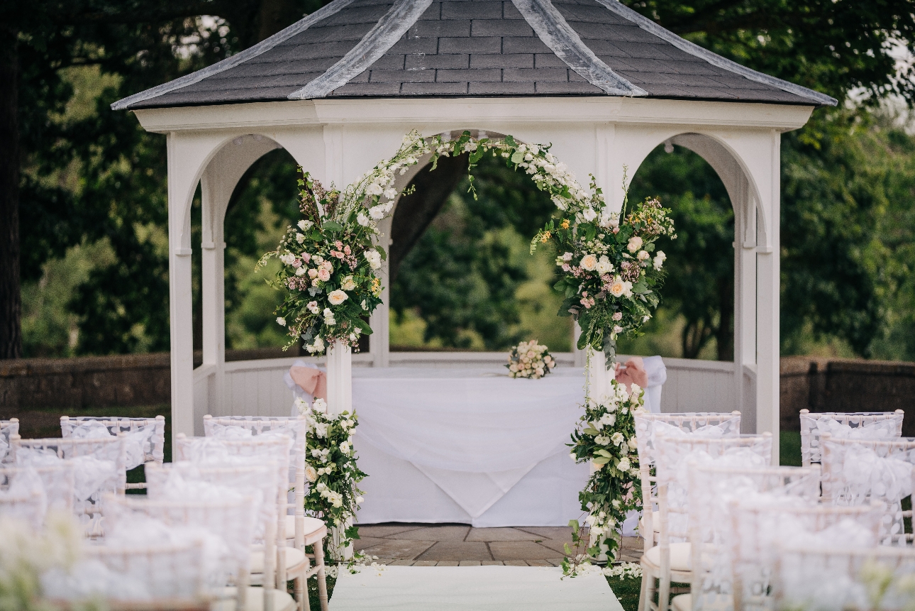 outdoor wedding gazebo covered in flowers