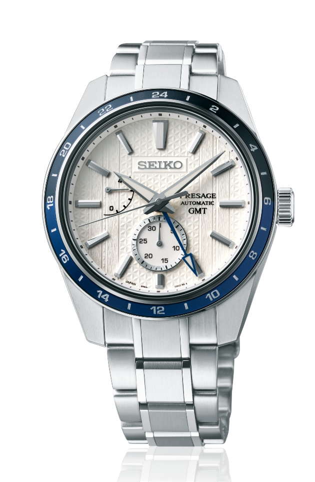 Silver Seiko Watch with a white face and a blue bezel