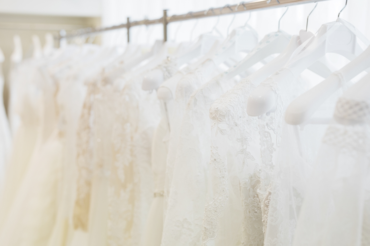 rows of wedding dresses on hangers