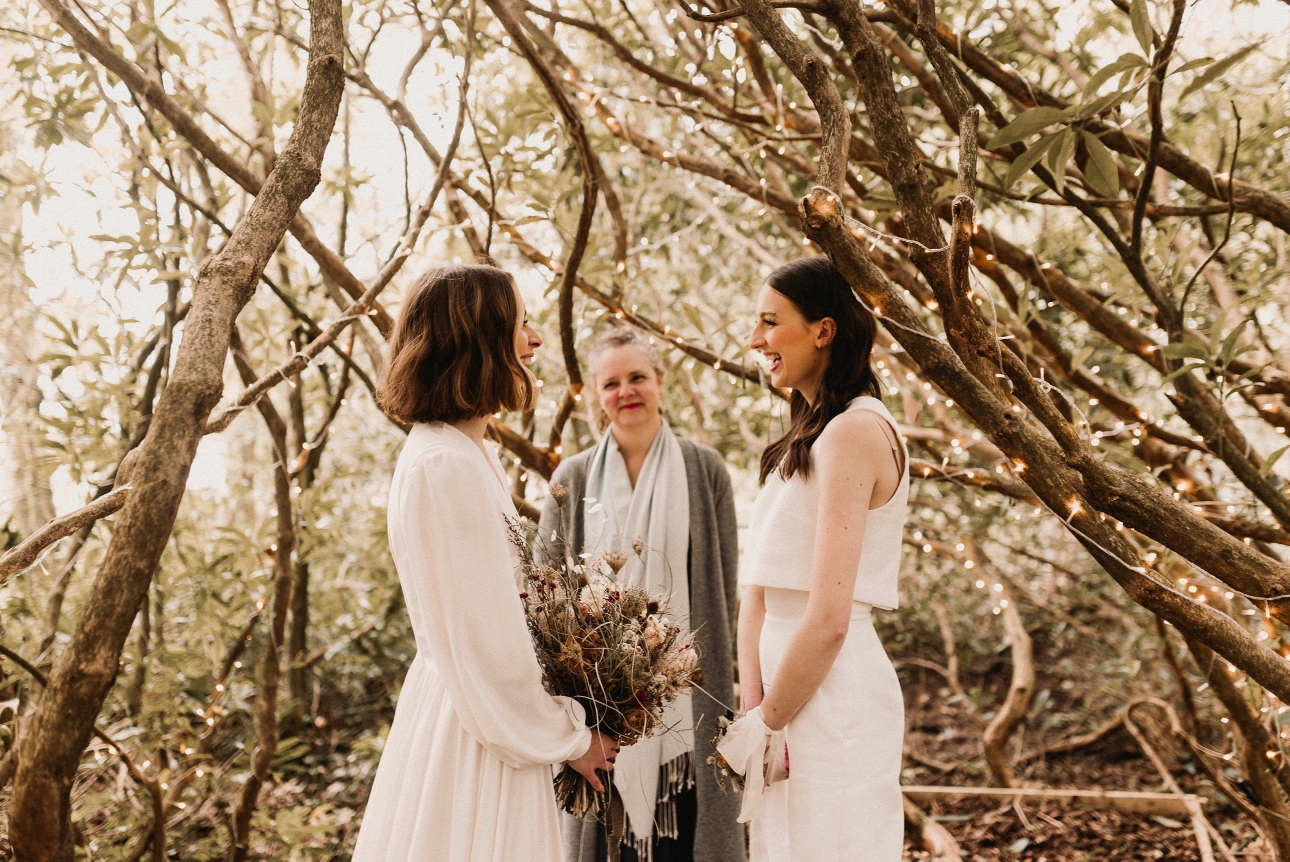 two women standing in a wood with a celebrant