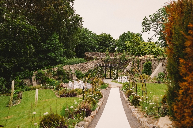 garden wedding setting with path down the middle of flowers