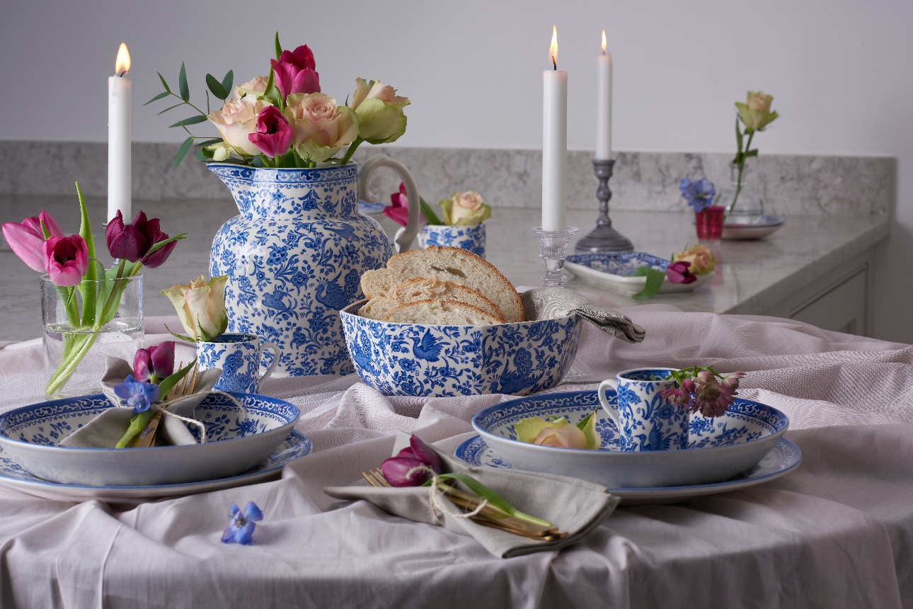 table decorated with lots of coordinating objects like plates in a blue and white pattern