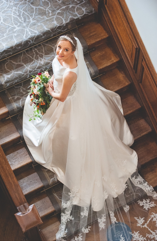 Bride looks up on stairwell