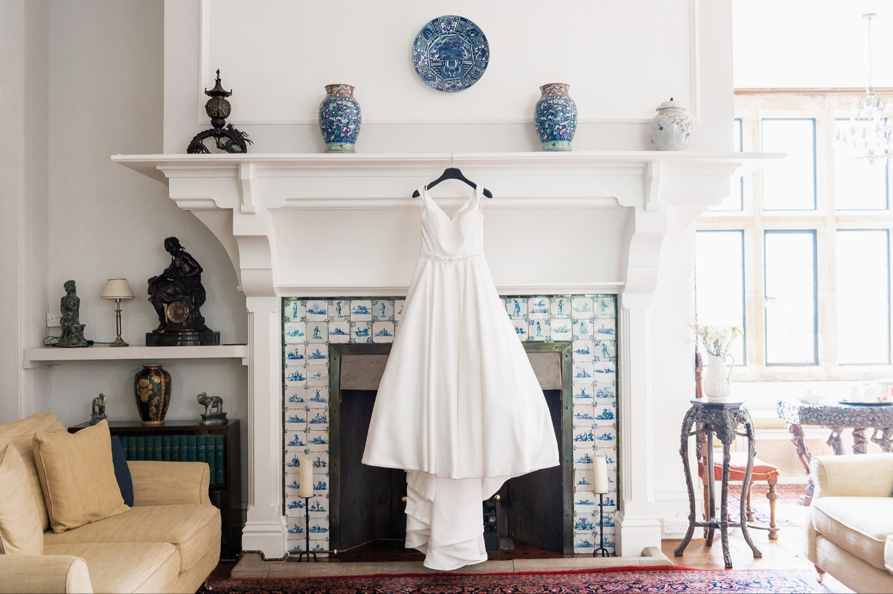Bride's dress hangning over fireplace