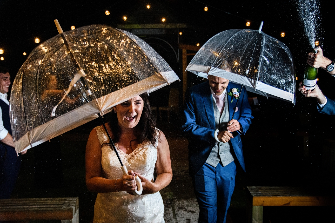Couple under umbrellas